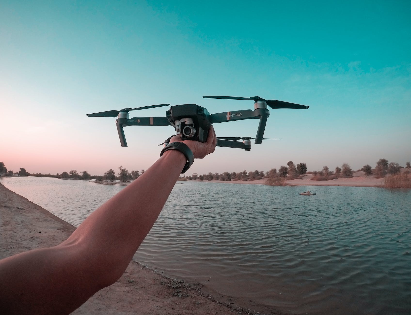 photo of a person holding a drone